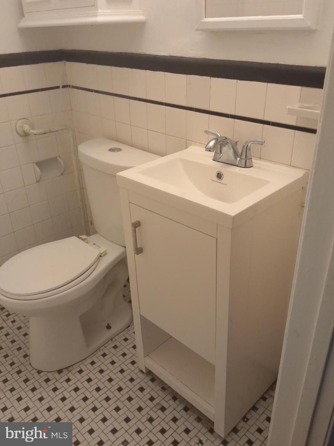 1205 30th Street Southeast Washington, DC 20019 - Photo 5 of 8 a white toilet sitting next to a bathroom sink