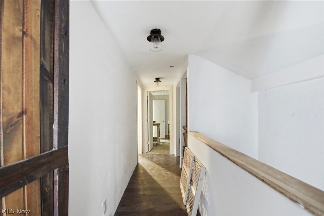 2591 Wayland Road Deerfield, OH 44411 - Photo 25 of 46 Hallway with wood-finish flooring and white walls