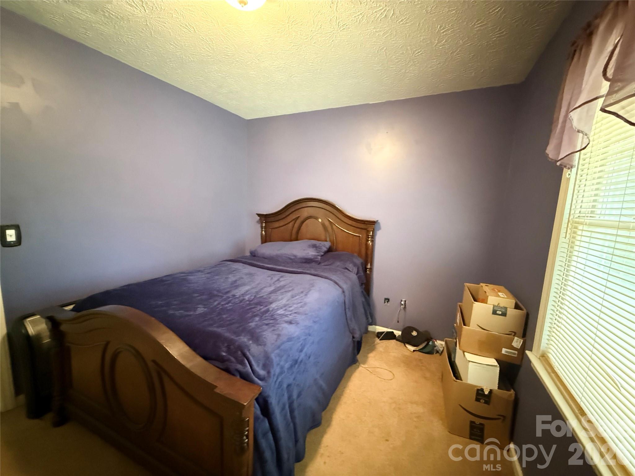 580 Legion Road Lenoir, NC 28645 - Photo 13 of 22 a bedroom with a bed and wooden floor