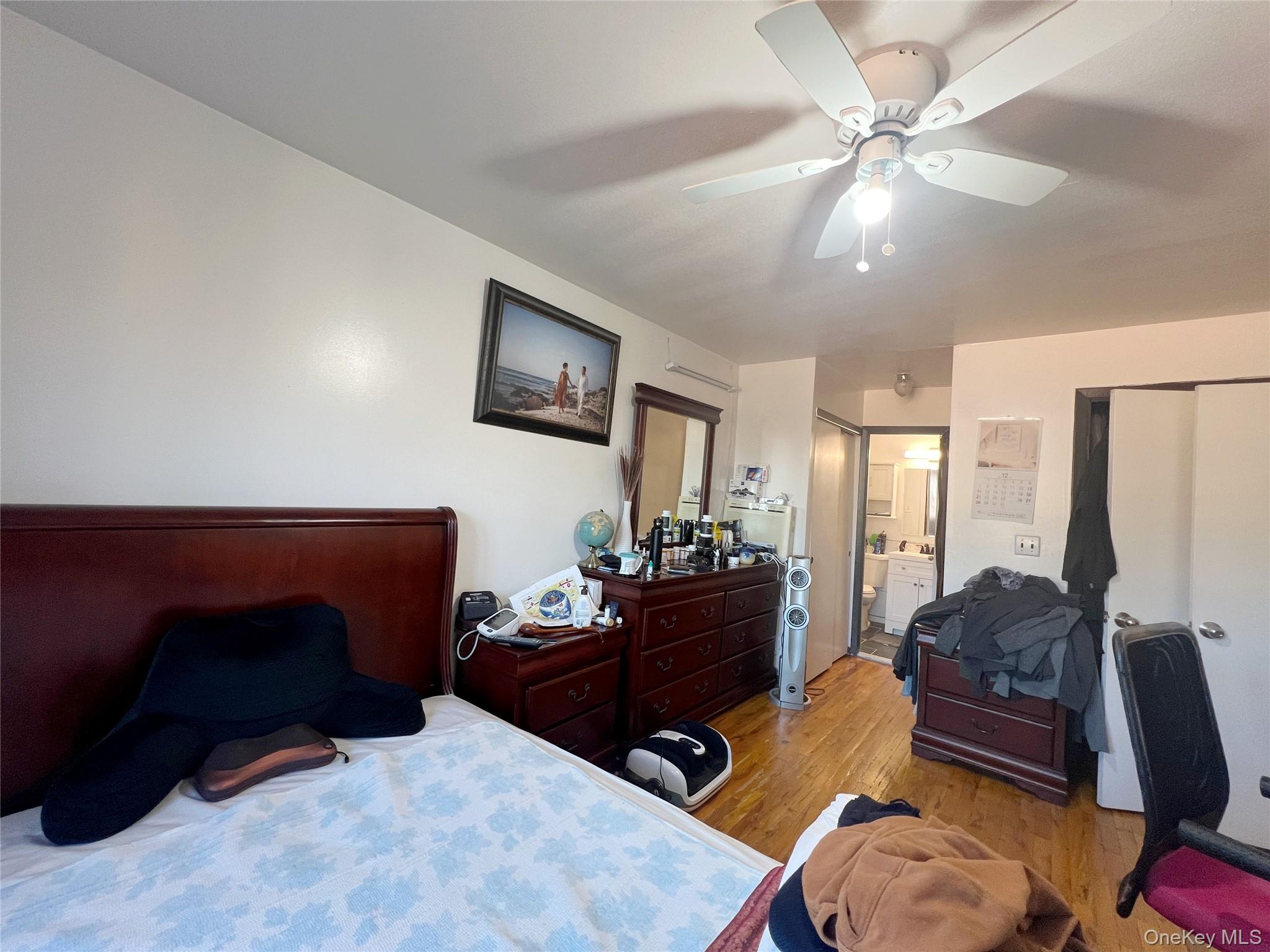 219-74 64th Avenue, Unit 239 Queens, NY 11364 - Photo 5 of 12 a living room with furniture and a flat screen tv
