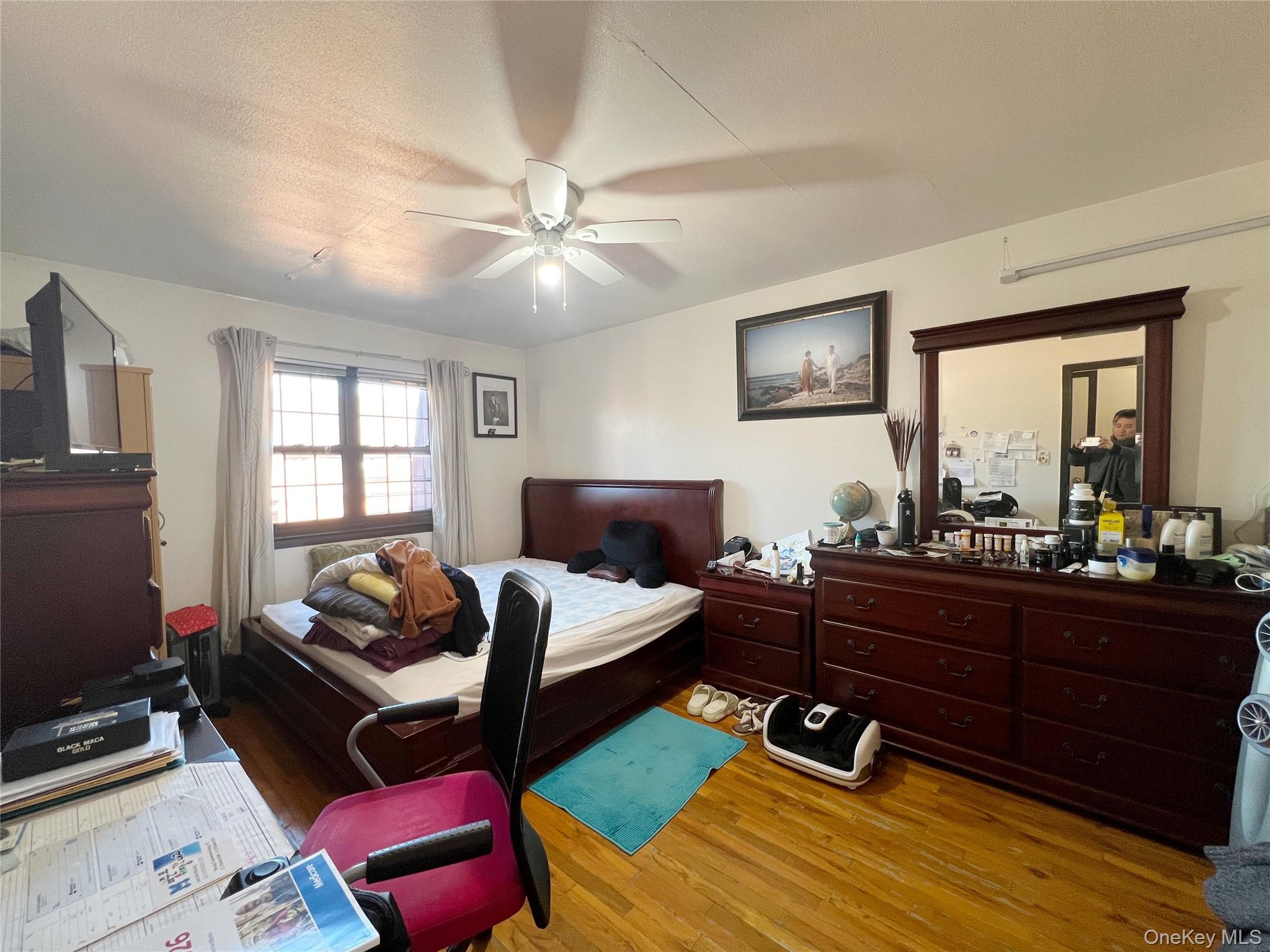 219-74 64th Avenue, Unit 239 Queens, NY 11364 - Photo 6 of 12 a bedroom with a bed and wooden floor
