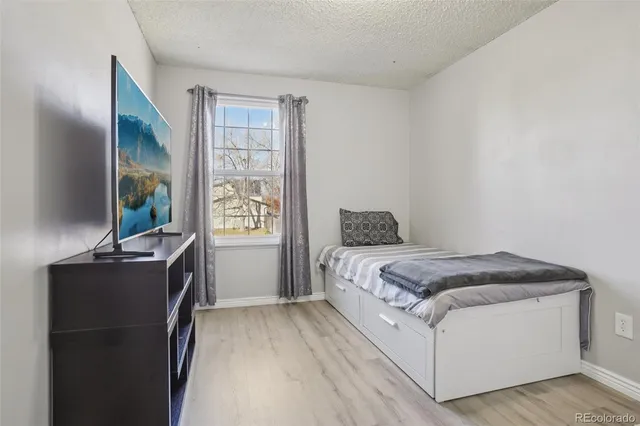 a bedroom with a bed and a view of kitchen