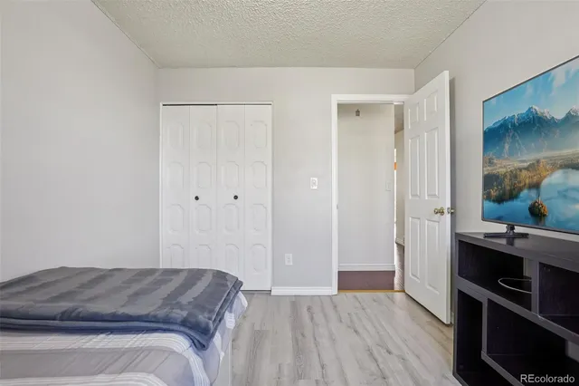 a bed sitting in a bedroom next to a window