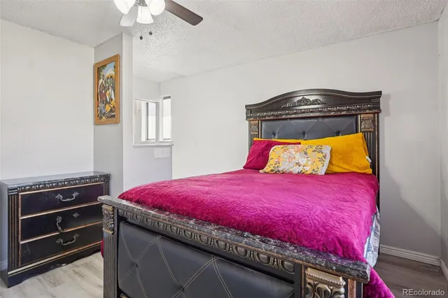 a bed sitting in a bedroom and a chandelier