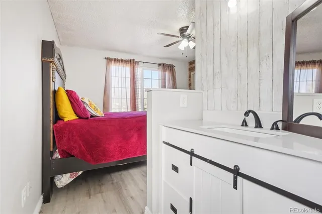 a bathroom with a toilet sink vanity and mirror