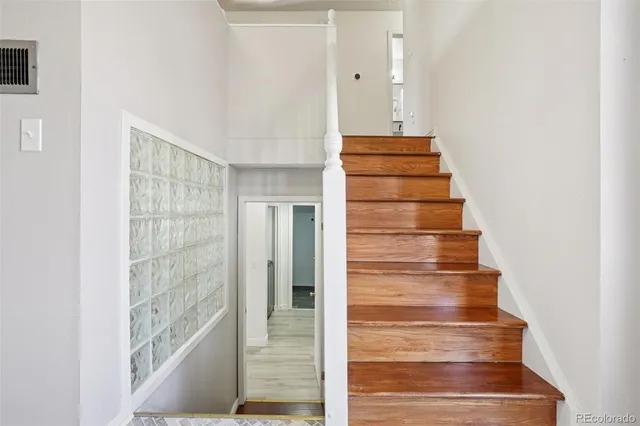 a living room with furniture a wooden floor and a flat screen tv