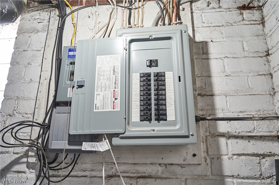 136 Smith Avenue Northwest Canton, OH 44708 - Photo 13 of 19 Electrical panel with multiple circuits installed on a white-painted brick wall