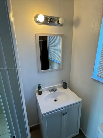 a bathroom with a sink and mirror