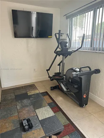 a room with gym equipment and a large window