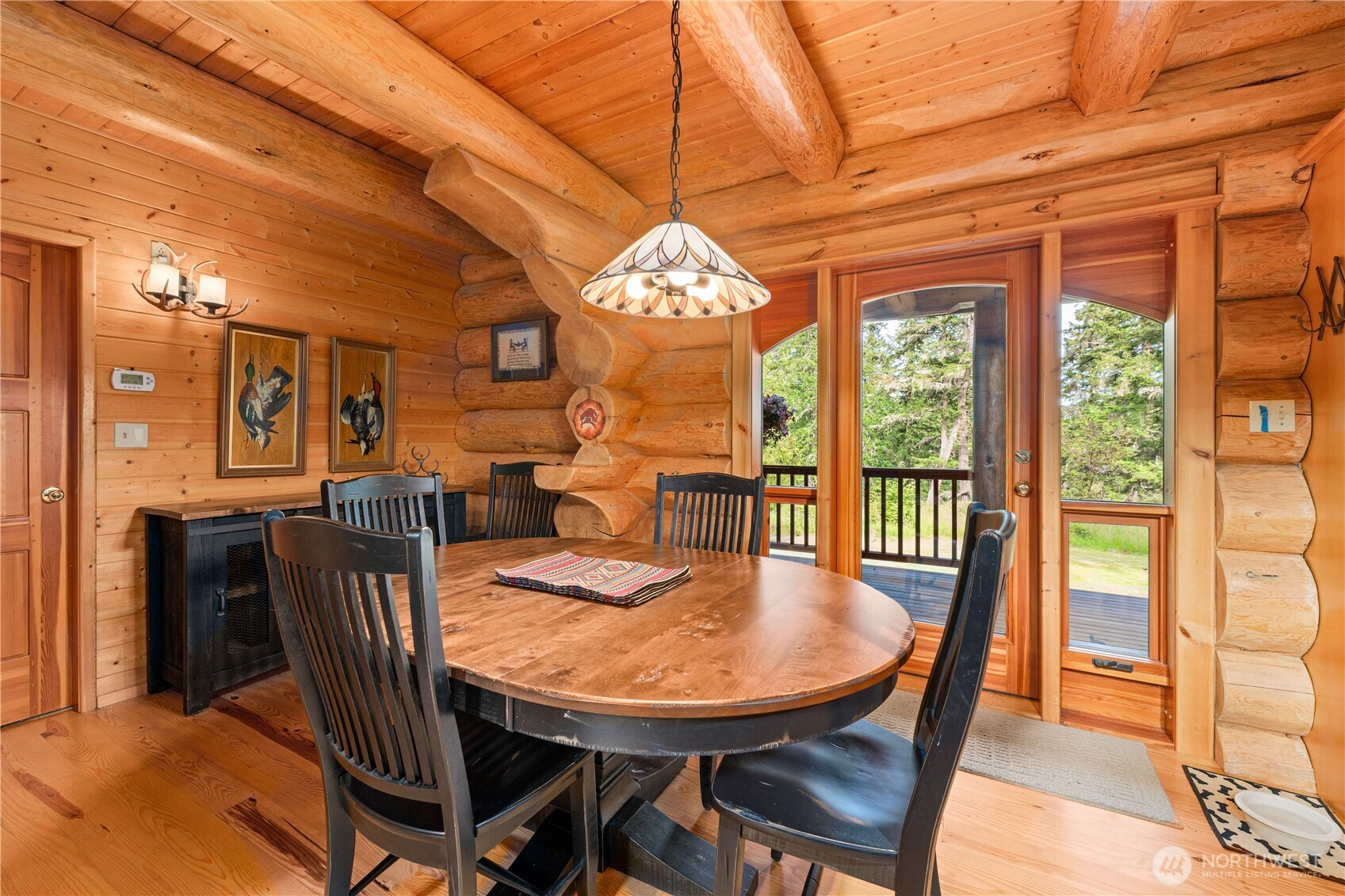 134 Sacred Moon Way Friday Harbor, WA 98250 - Photo 15 of 35 a view of a dining room with furniture a chandelier and wooden floor