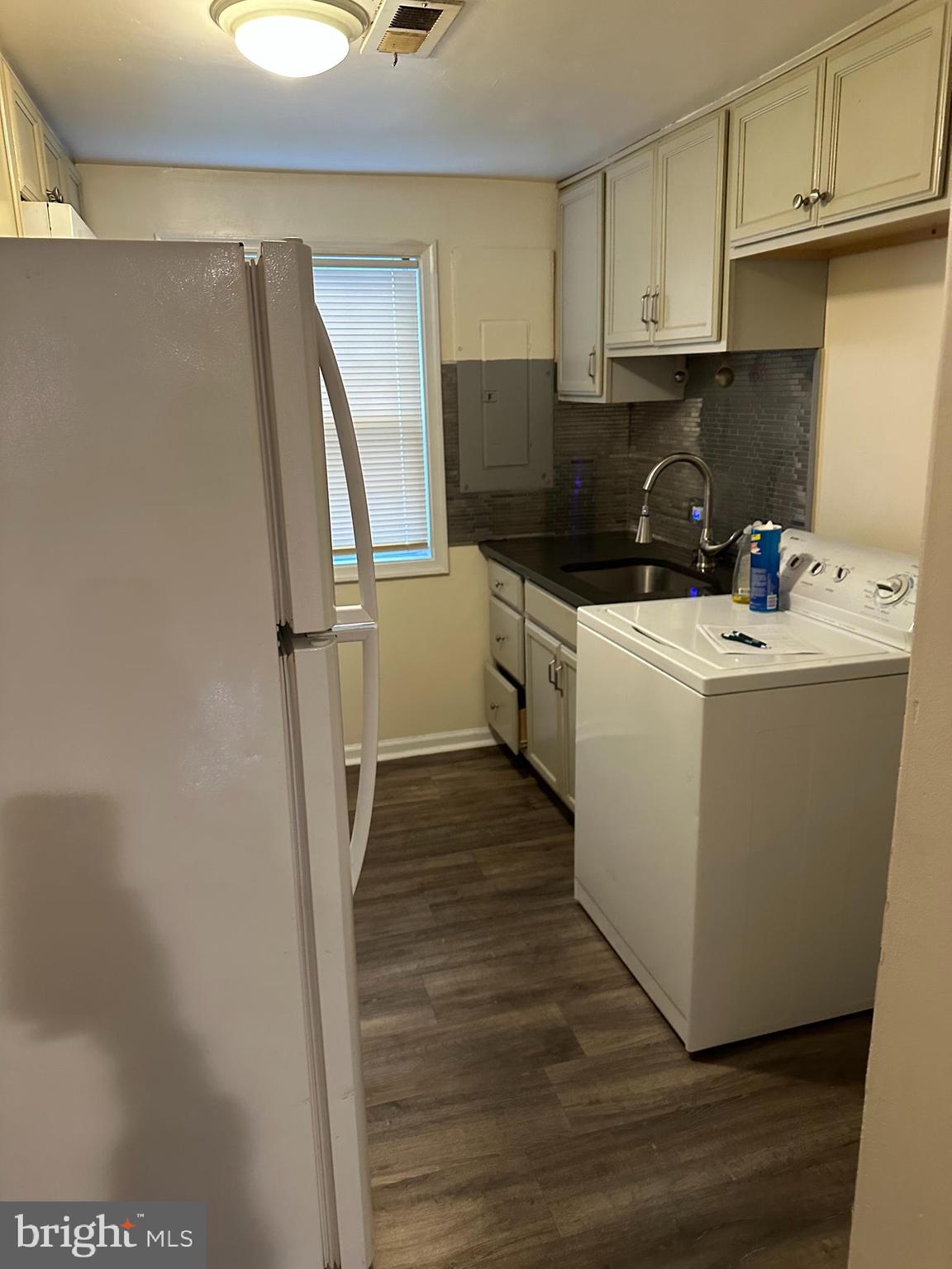 401 Maple Lane Dundalk, MD 21222 - Photo 12 of 15 a view of a kitchen with fridge and wooden floor