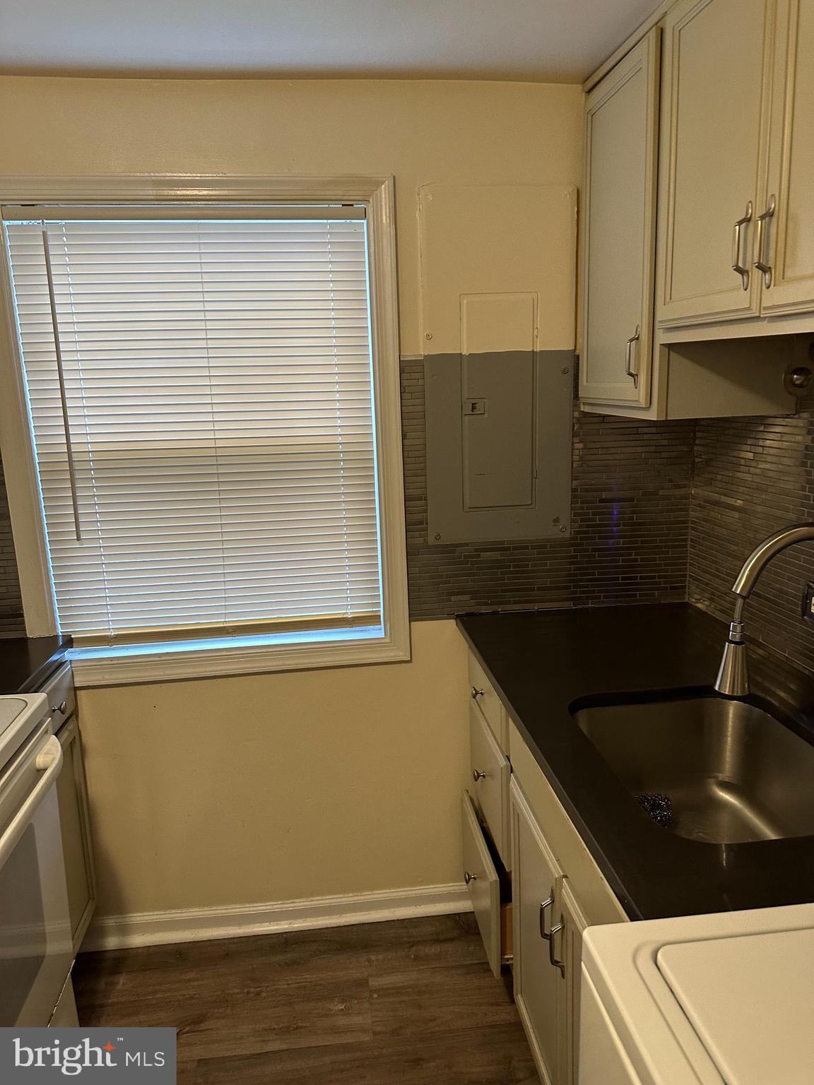 401 Maple Lane Dundalk, MD 21222 - Photo 15 of 15 a kitchen with a sink and a refrigerator