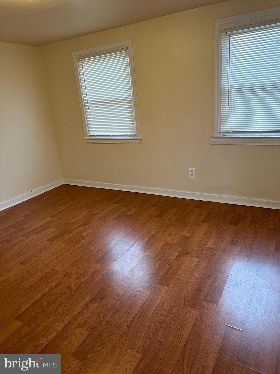 401 Maple Lane Dundalk, MD 21222 - Photo 2 of 15 an empty room with wooden floor and windows