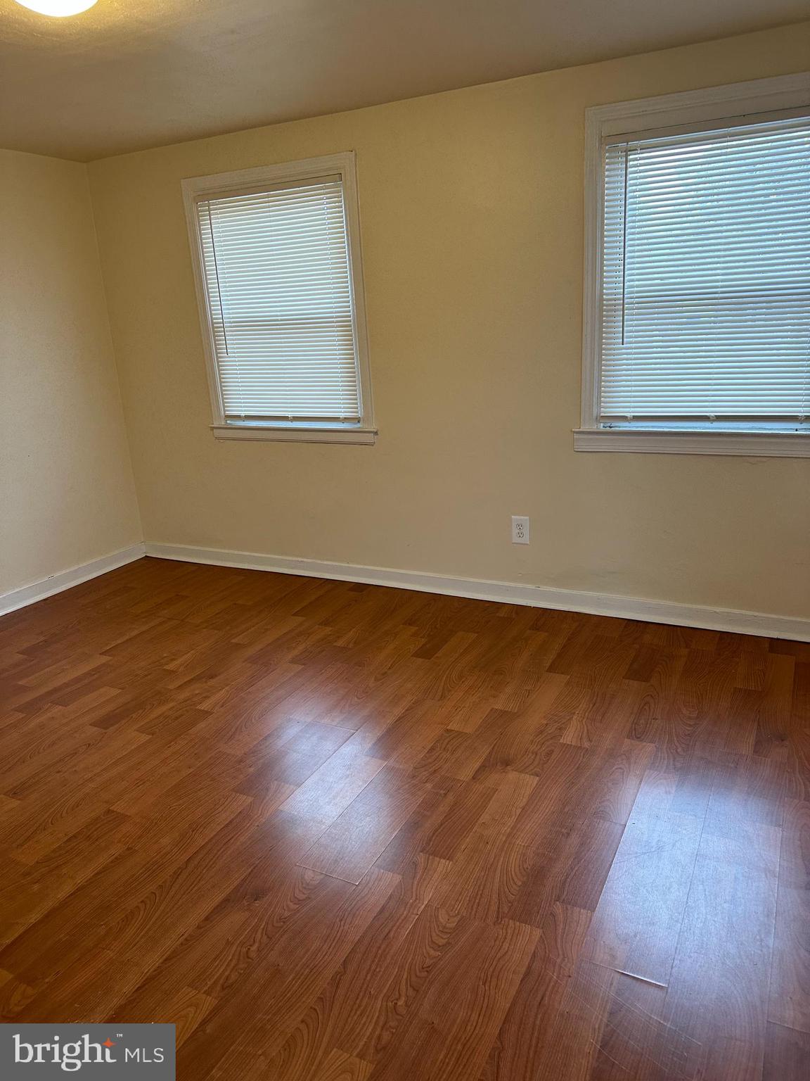 401 Maple Lane Dundalk, MD 21222 - Photo 3 of 15 an empty room with wooden floor and windows