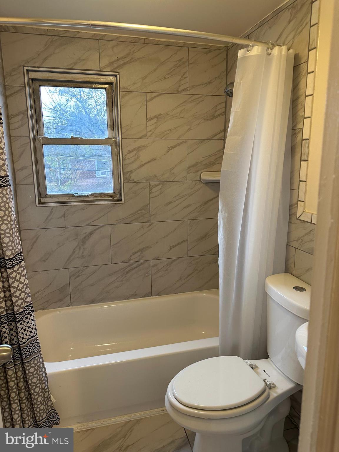 401 Maple Lane Dundalk, MD 21222 - Photo 5 of 15 a bathroom with a toilet and a bathtub