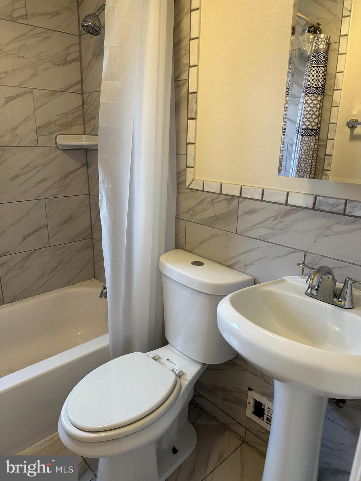 401 Maple Lane Dundalk, MD 21222 - Photo 6 of 15 a bathroom with a sink a toilet and bathtub