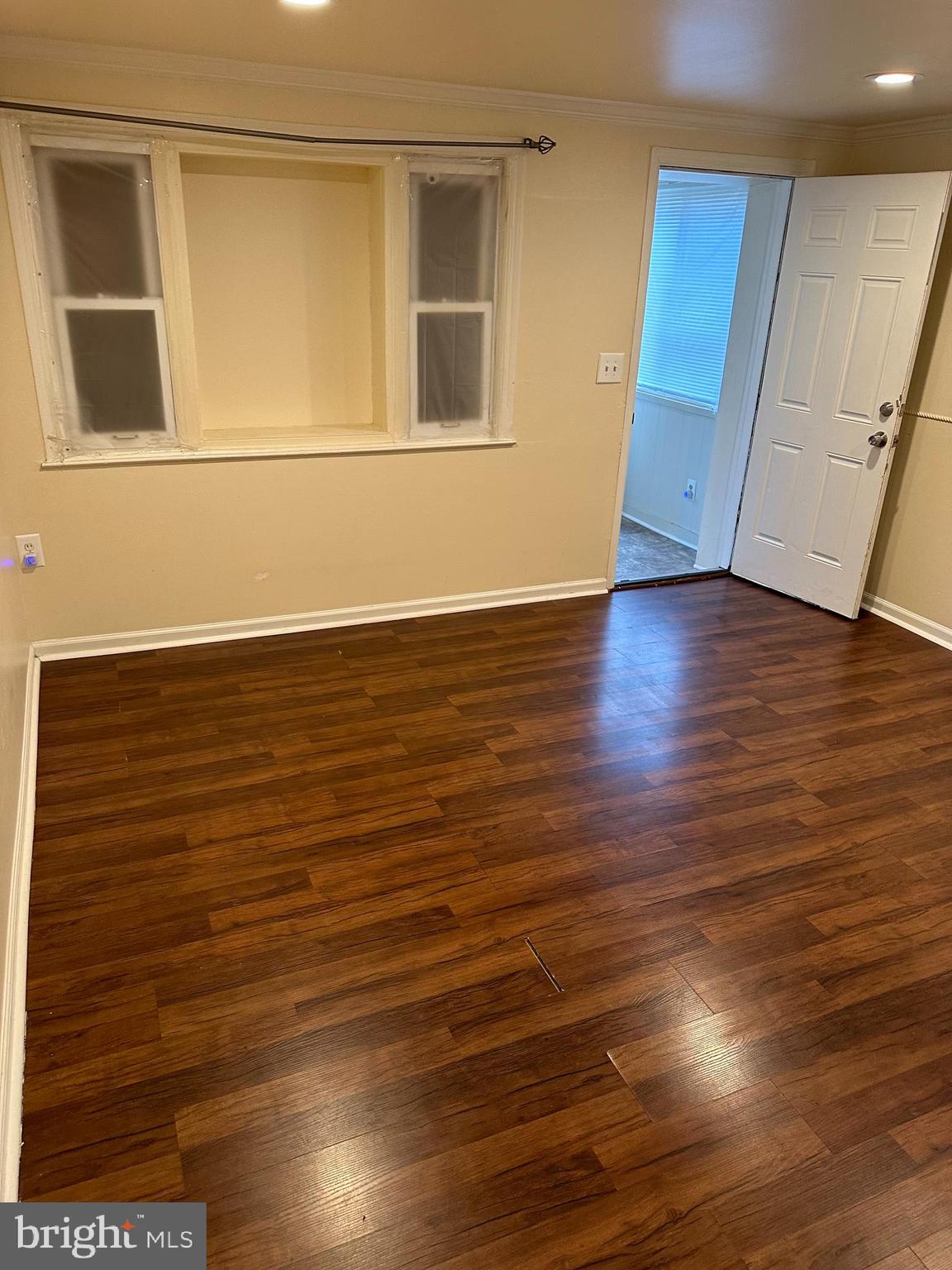 401 Maple Lane Dundalk, MD 21222 - Photo 8 of 15 a view of an empty room with wooden floor and a window