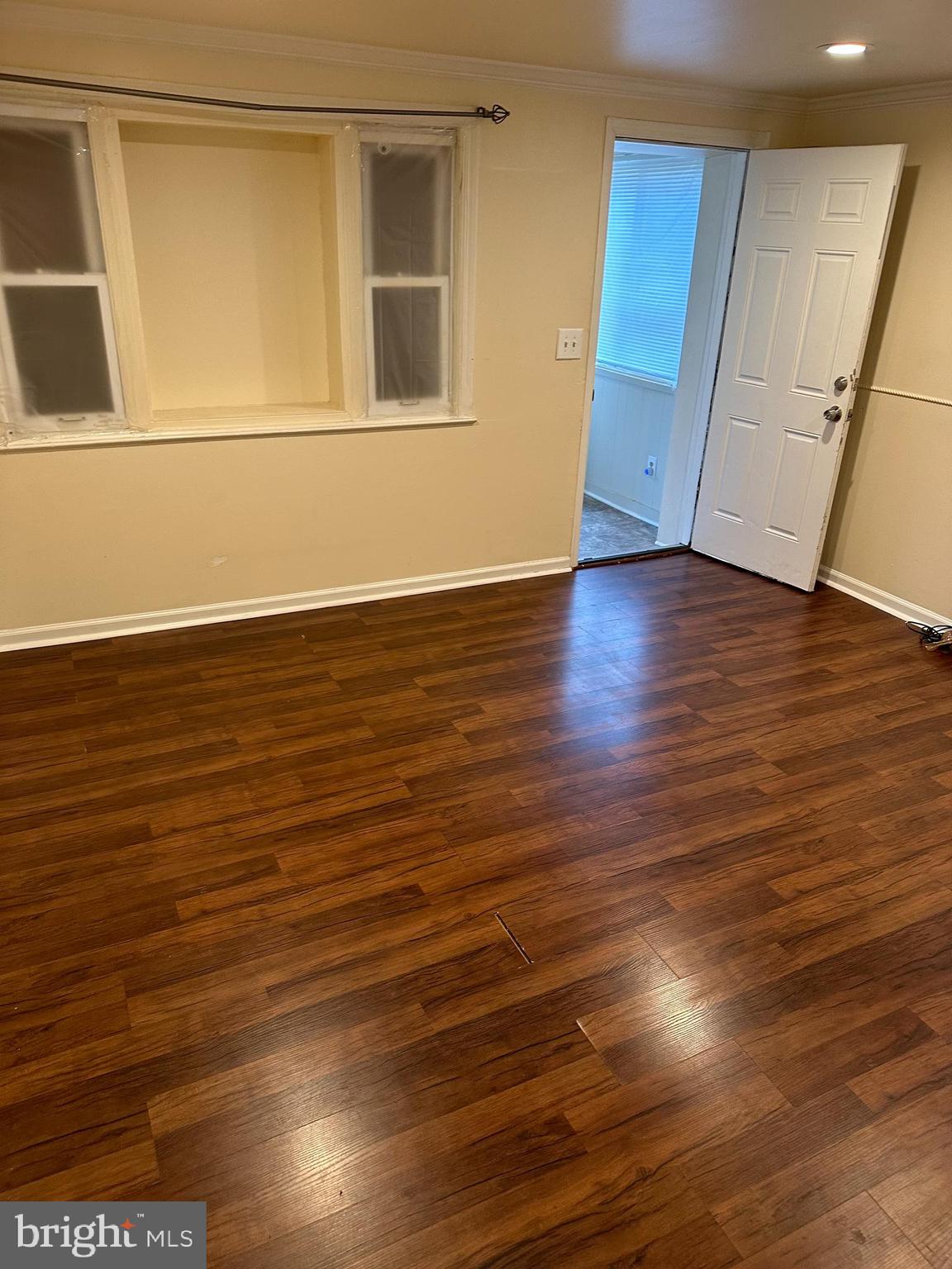 401 Maple Lane Dundalk, MD 21222 - Photo 9 of 15 a view of an empty room with wooden floor and a window