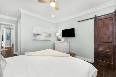 a bedroom with a large bed and a flat screen tv