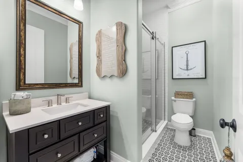 a spacious bathroom with a double vanity sink and a large mirror