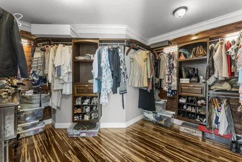 a front view of a house with a yard and trees