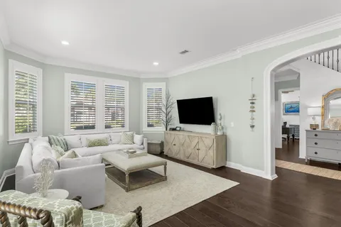 a living room with furniture wooden floor and a table