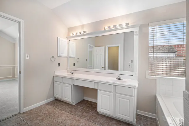 a bathroom with a double vanity sink mirror and