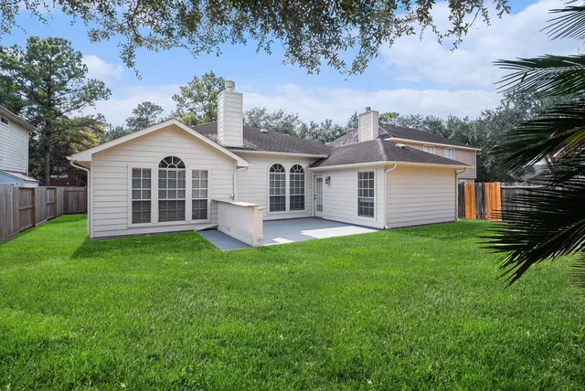 a view of a house with a backyard
