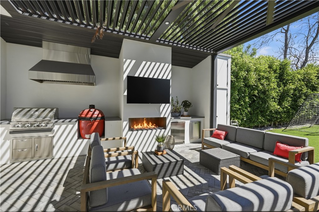 1852 6th Street Manhattan Beach, CA 90266 - Photo 3 of 58 27'X21' fully decked out patio with grill, fireplace, smoker, fridge, and TV for outdoor gatherings while the kids and pets play!