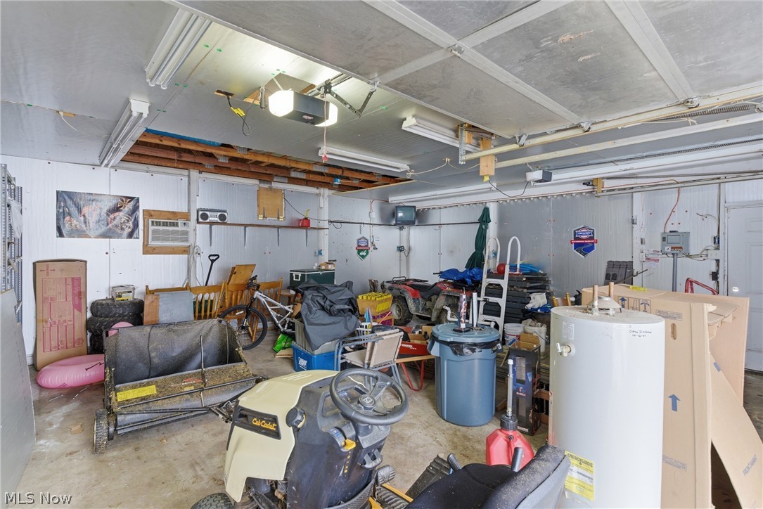 6291 Downs Road Northwest Warren, OH 44481 - Photo 31 of 44 Garage with water heater and a garage door opener