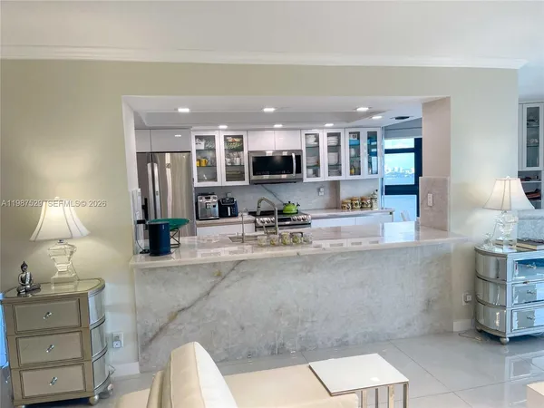 a large kitchen with kitchen island granite countertop a large counter top stainless steel appliances and cabinets