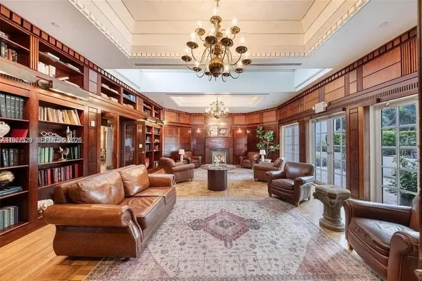 a living room with fireplace furniture and a chandelier