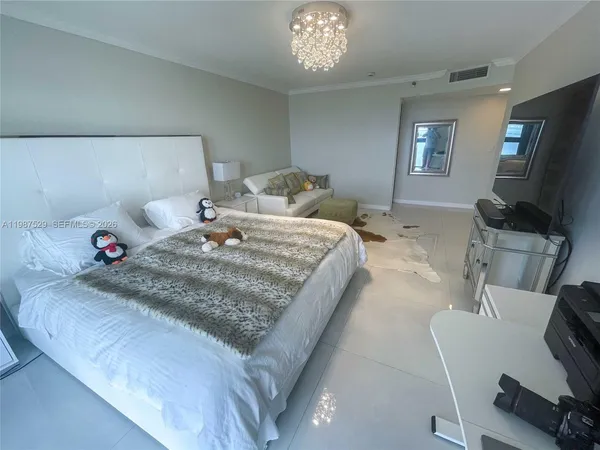 a bedroom with a bed and flat screen tv
