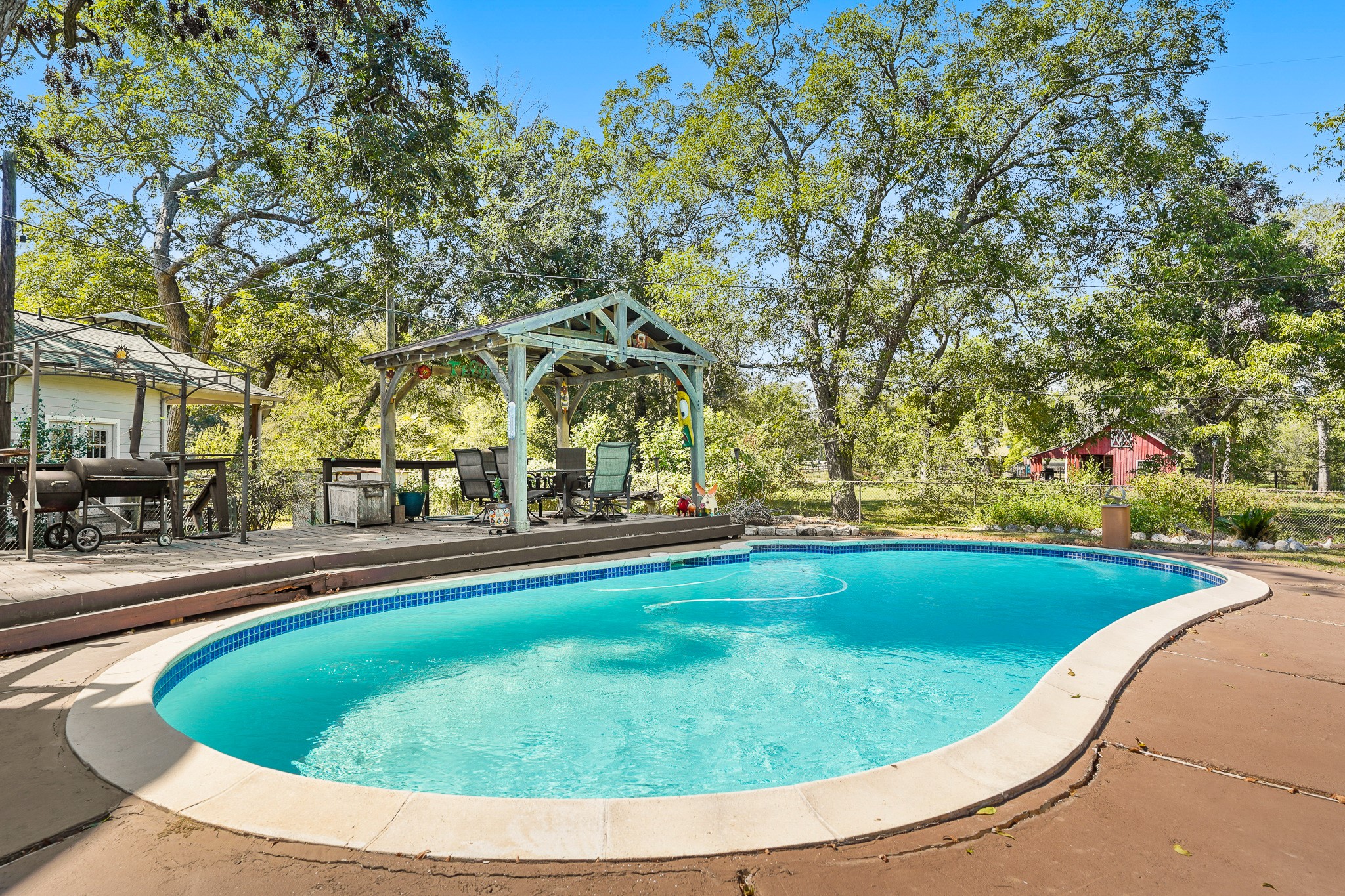 1505 Wagon Road Simonton, TX 77485 - Photo 28 of 50 a view of swimming pool with outdoor seating and plants