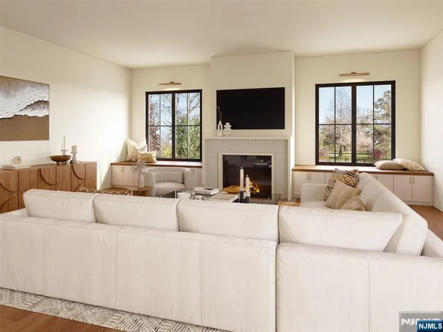 a living room with furniture a flat screen tv and a fireplace