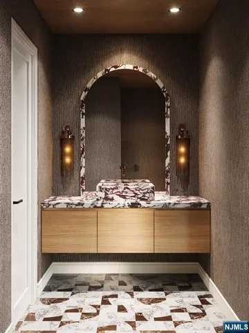 a view of a bathroom with a sink and chandelier