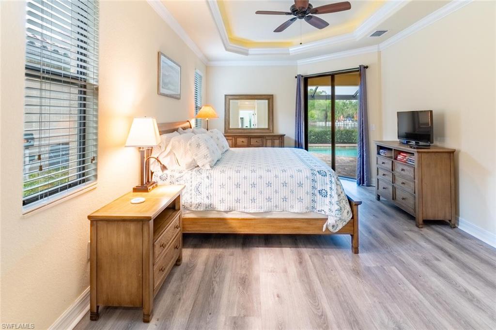 9458 Piacere Way Naples, FL 34113 - Photo 18 of 50 a bedroom with a bed and a flat screen tv