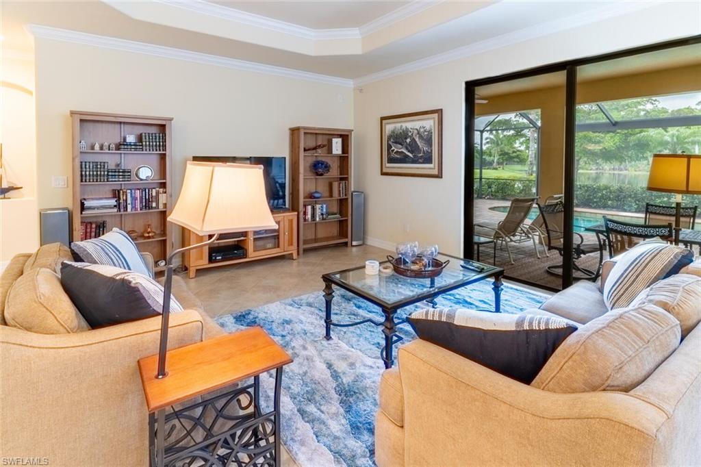 9458 Piacere Way Naples, FL 34113 - Photo 8 of 50 a living room with furniture and a flat screen tv