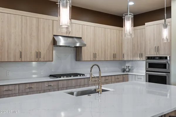 a large kitchen with a table chairs refrigerator and microwave