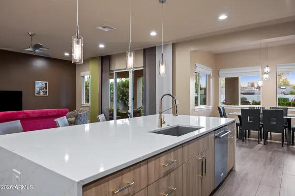 a kitchen with stainless steel appliances granite countertop a sink and a stove top oven