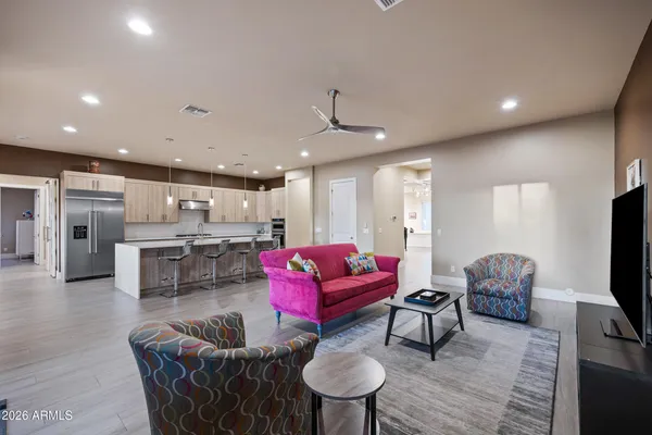 a large kitchen with kitchen island a sink and a refrigerator