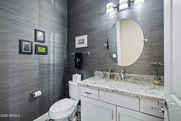 a view of a dining room with furniture a chandelier and wooden floor