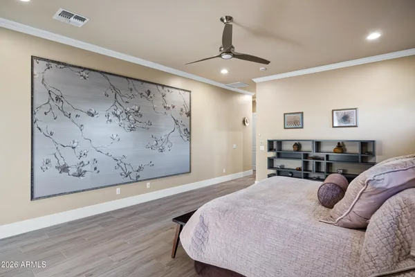 a spacious bedroom with a bed and a chandelier
