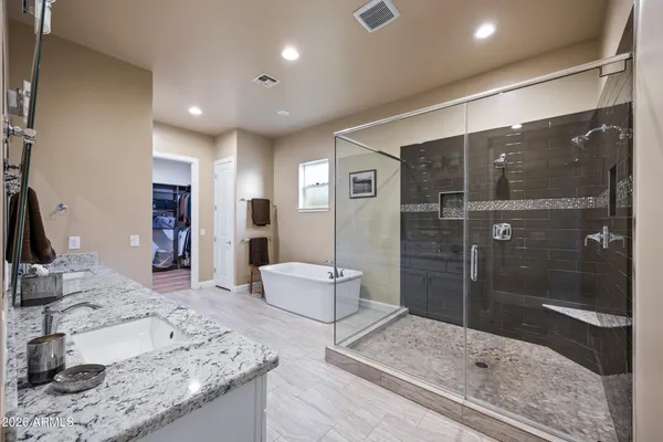 a bathroom with a tub sink and mirror