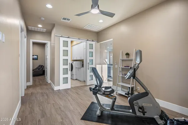 a view of a livingroom with hardwood floor and a workspace