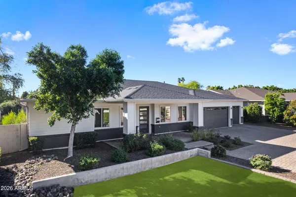 a view of a house with backyard and sitting area
