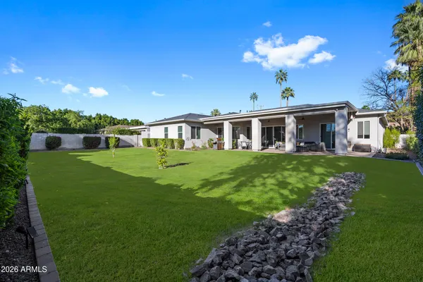 a bathroom with a granite countertop sink a toilet a shower and a mirror