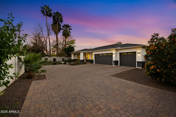a view of a house with a yard and garage