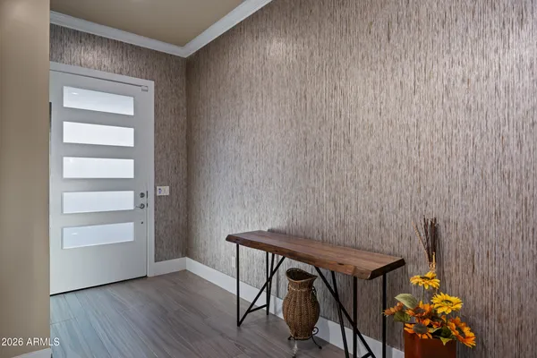 a view of a house with chairs and table in a patio