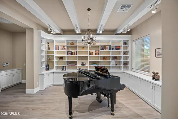 a view of a room with wooden floor and furniture